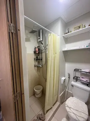 a bathroom with a shower and a toilet in it at Modern japan home in the Philippines in Manila