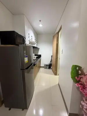 a kitchen with a stainless steel refrigerator and white walls at Modern japan home in the Philippines in Manila