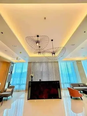 a living room with a flat screen tv and chairs at Modern japan home in the Philippines in Manila