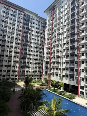 two large apartment buildings with a swimming pool and palm trees at Modern japan home in the Philippines in Manila