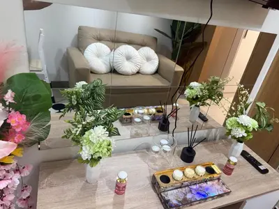 a living room with a couch and a table with flowers at Modern japan home in the Philippines in Manila