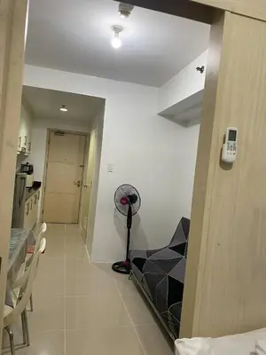 a hallway with a room with a vacuum in it at Janas Condotel in Manila