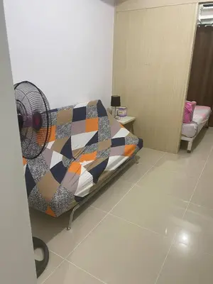 a hospital room with a bed and a fan at Janas Condotel in Manila