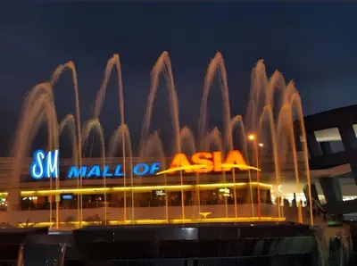 a building with a water fountain in front of it at Sy bay in Manila
