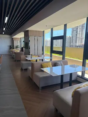 a lobby with couches and tables and large windows at Sy bay in Manila