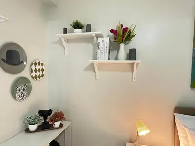 a room with shelves and plants on a wall at Casa De Ciudad - Shore Residences MOA PASAY in Manila