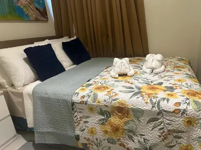 a bedroom with a bed with towels on it at Casa De Ciudad - Shore Residences MOA PASAY in Manila