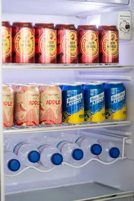 a refrigerator filled with lots of cans of soda at SM Bicutan Condotels Felis in Manila