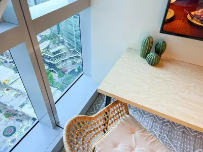 a room with a table and a chair next to a window at Prime Uptown BGC | Stylish 1BR Getaway #upt1 35j in Manila