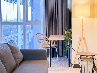 a living room with a couch and a table at Prime Uptown BGC | Stylish 1BR Getaway #upt1 35j in Manila