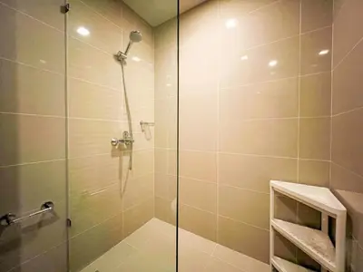 a shower with a glass door in a bathroom at Prime Uptown BGC | Stylish 1BR Getaway #upt1 35j in Manila