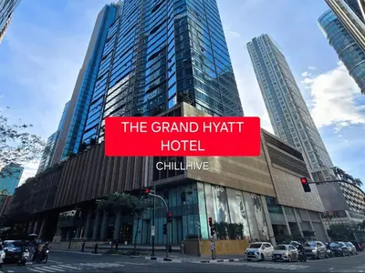 a sign for the grand hyatt hotel in a city at Prime Uptown BGC | Stylish 1BR Getaway #upt1 35j in Manila