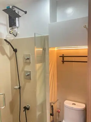 a bathroom with a shower and a toilet at Casa Cion Staycation in Manila