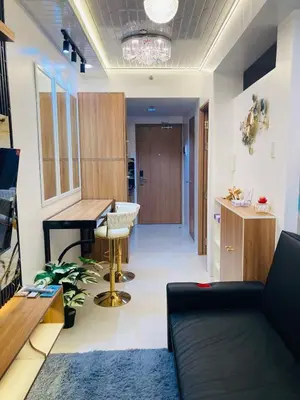 a living room with a couch and a table at Casa Cion Staycation in Manila
