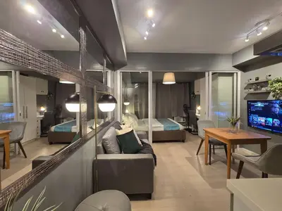 a living room with a couch and a bedroom at 1BR Condotel at Azure Urban Resort Near Airport #AZ07 in Manila