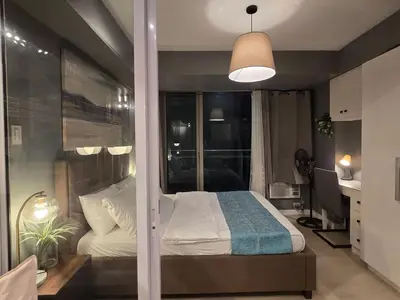 a bedroom with a bed and a large window at 1BR Condotel at Azure Urban Resort Near Airport #AZ07 in Manila