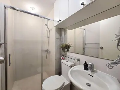 a bathroom with a toilet and a sink and a shower at 1BR Condotel at Azure Urban Resort Near Airport #AZ07 in Manila