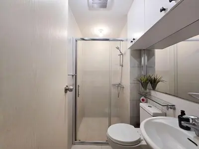 a bathroom with a shower and a toilet and a sink at 1BR Condotel at Azure Urban Resort Near Airport #AZ07 in Manila