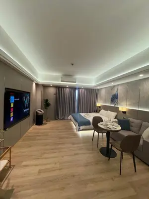 a living room with a couch and a bed and a table at Venice Luxe Stay, Studio Type, King Bed, 65 TV-Netflix 40\u5e73\u65b9\u56db\u4eba\u516c\u5bd3 \u53a8\u5177\u9f50\u5168 in Manila
