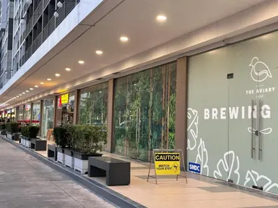a shopping mall with a sign in front of a store at Avocado Room near MOA PICC 2 BEDS in Manila