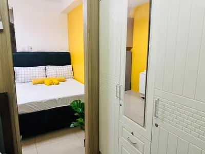 a bedroom with a bed with a stuffed animal on it at Mango Room near MOA STARCITY 2 Beds in Manila