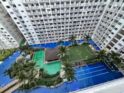an overhead view of a tennis court in front of a large building at Mango Room near MOA STARCITY 2 Beds in Manila