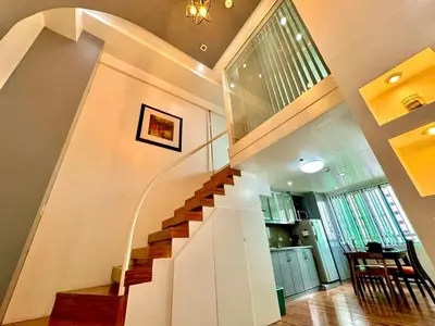 a spiral staircase in a home with a stair case at Entire Condo loft in Mandaluyong in Manila