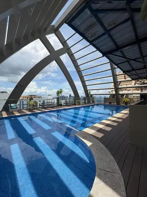 a swimming pool on the roof of a building at Entire Condo loft in Mandaluyong in Manila