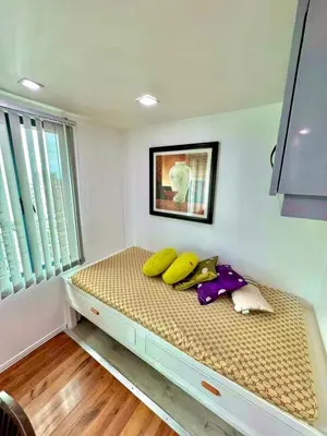 a bed with bananas on it in a room at Entire Condo loft in Mandaluyong in Manila
