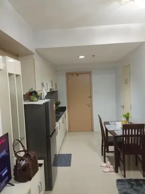 a kitchen and dining room with a table and a dining room at Sea Residences david in Manila