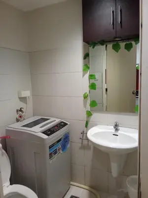 a small bathroom with a sink and a toilet at Sea Residences david in Manila