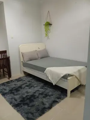 a bed in a room with a rug at Sea Residences david in Manila