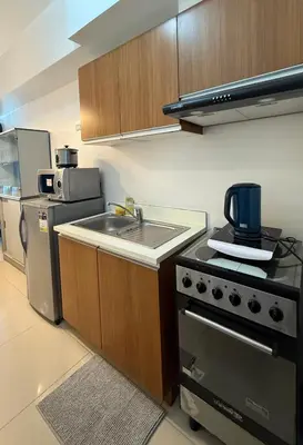 a small kitchen with a stove and a sink at Condo in Ermita near UP-PGH, St Lukes & US Embassy in Manila