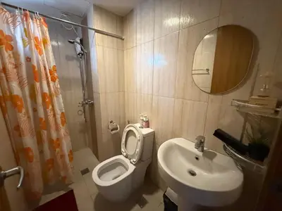a bathroom with a toilet and a sink at Condo in Ermita near UP-PGH, St Lukes & US Embassy in Manila