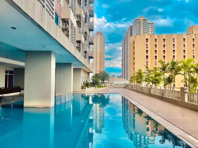 a swimming pool in a city with tall buildings at Condo in Ermita near UP-PGH, St Lukes & US Embassy in Manila