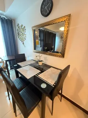 a dining room with a table and a mirror at Condo in Ermita near UP-PGH, St Lukes & US Embassy in Manila