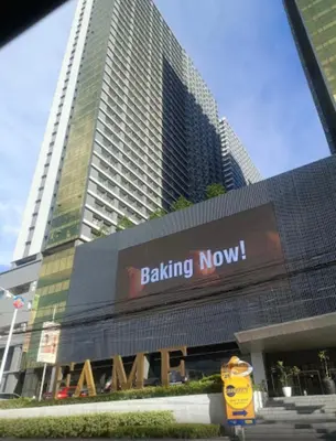 a building with a boxing now sign in front of buildings at KakaI's Staycation in Fame in Manila