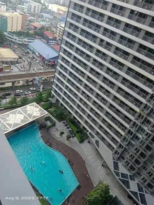 an aerial view of a large building with a swimming pool at KakaI's Staycation in Fame in Manila