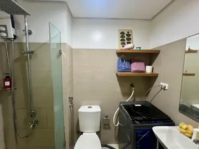 a bathroom with a shower and a toilet and a sink at Shore residences A 1br Near SM MOA in Manila