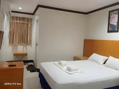 a bedroom with a large white bed in a room at Jeamco Royal Hotel - Pasig in Manila