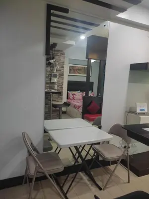 a table and chairs in a room at LDN Staycation Booking partners in Manila