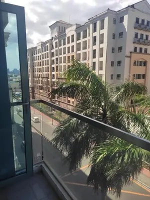 a balcony with a view of a palm tree at LDN Staycation Booking partners in Manila