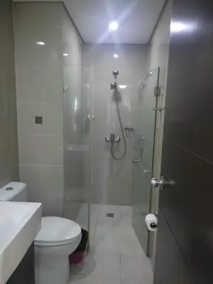 a bathroom with a glass shower with a toilet at LDN Staycation Booking partners in Manila