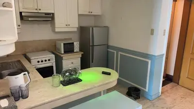 a kitchen with a refrigerator and a table in it at Whole Ocean View Manila Bay 4 Bedrooms in Manila