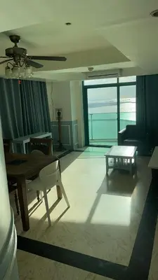 a living room with a table and a couch at Whole Ocean View Manila Bay 4 Bedrooms in Manila