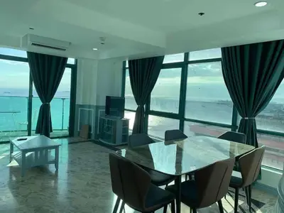 a dining room with a glass table and chairs at Whole Ocean View Manila Bay 4 Bedrooms in Manila