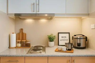 a kitchen counter with a stove and a sign on it at Modern & Luxury 1BR near Okada, Solaire, Airport in Manila