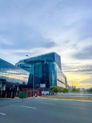 a large glass building on the side of a street at Modern & Luxury 1BR near Okada, Solaire, Airport in Manila