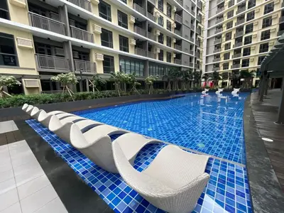 a swimming pool in the middle of a building at Modern & Luxury 1BR near Okada, Solaire, Airport in Manila