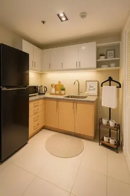 a kitchen with a refrigerator and a sink at Modern & Luxury 1BR near Okada, Solaire, Airport in Manila
